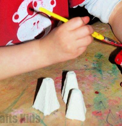 child painting egg carton pieces