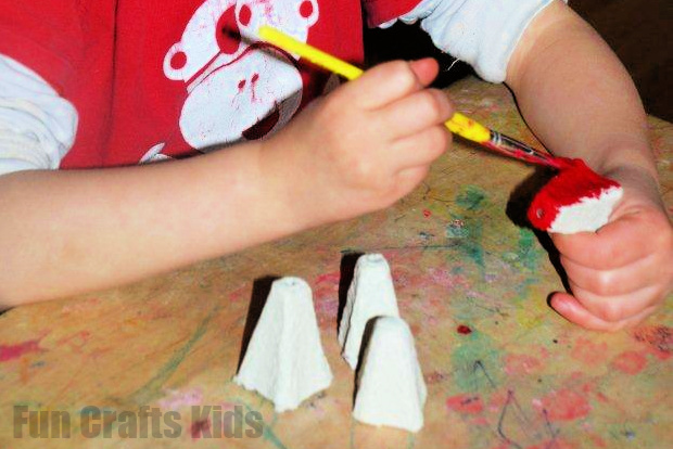 child painting egg carton pieces
